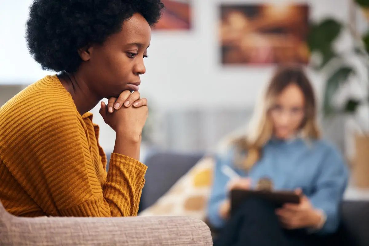 a woman struggling with addiction opens up to a counselor in treatment